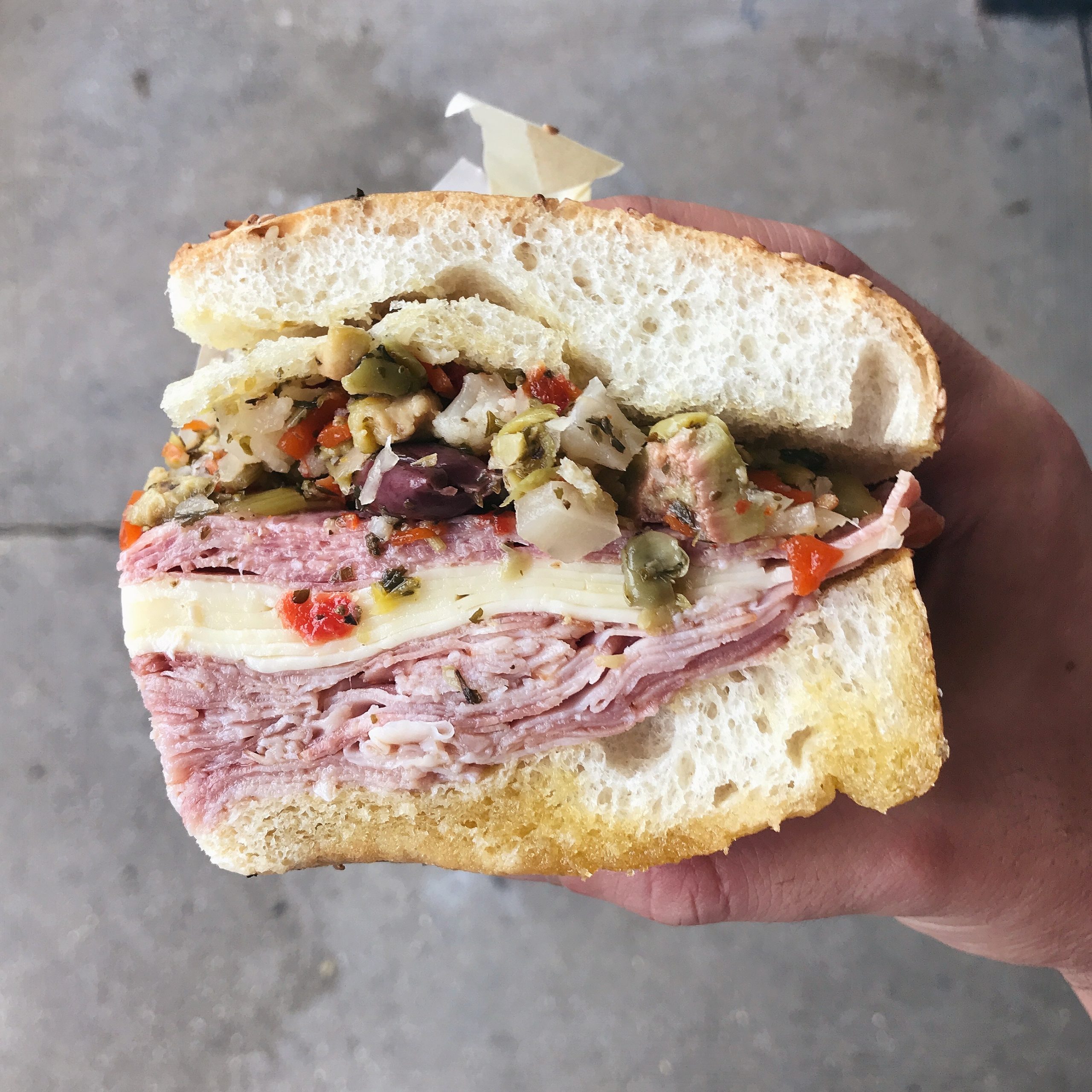 A New Orleans muffuletta sliced to show the layers